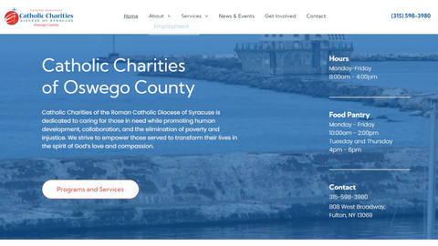 Catholic Charities of Oswego County homepage with blue hero banner and contact information