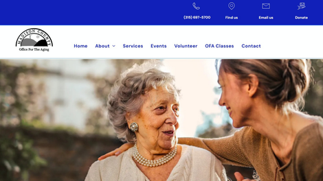 Two women smiling and talking on a website homepage with a blue navigation bar