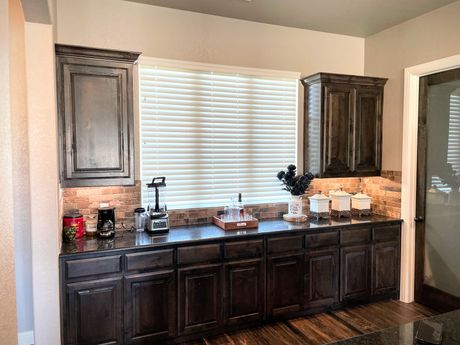 A kitchen with a lot of cabinets and a window.