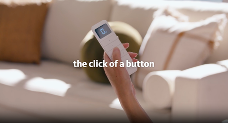 A person is holding a remote control in their hand.