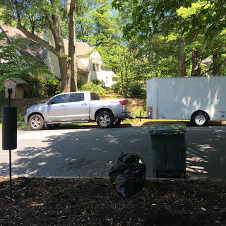 pickup truck and trailer parked along curb