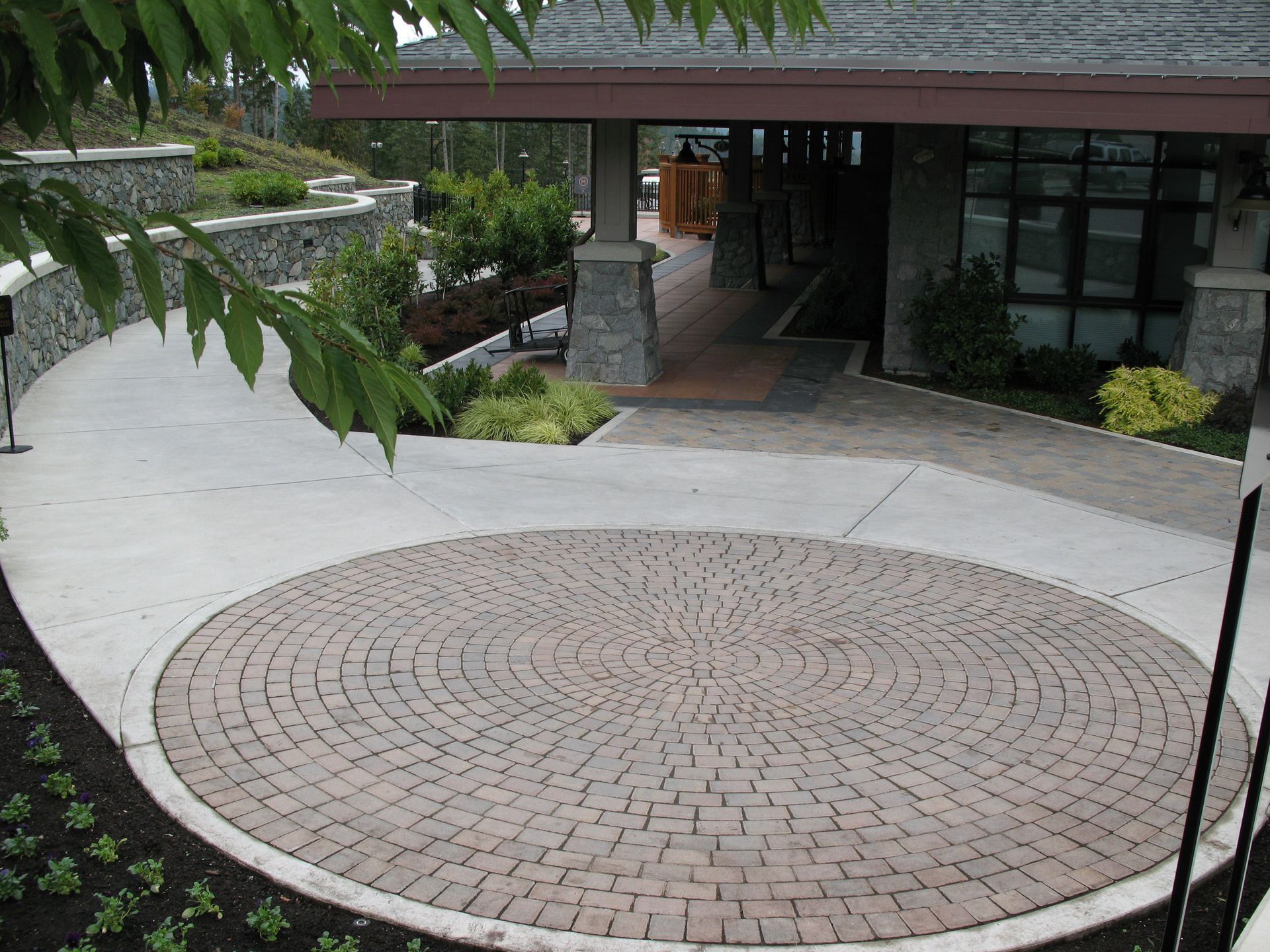 Large circular commercial patio installed in Langford BC by Larix Landscape