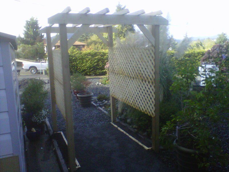 An image of a pergola garden trellis in a new garden landscape designed by Larix Landscape in Victoria BC