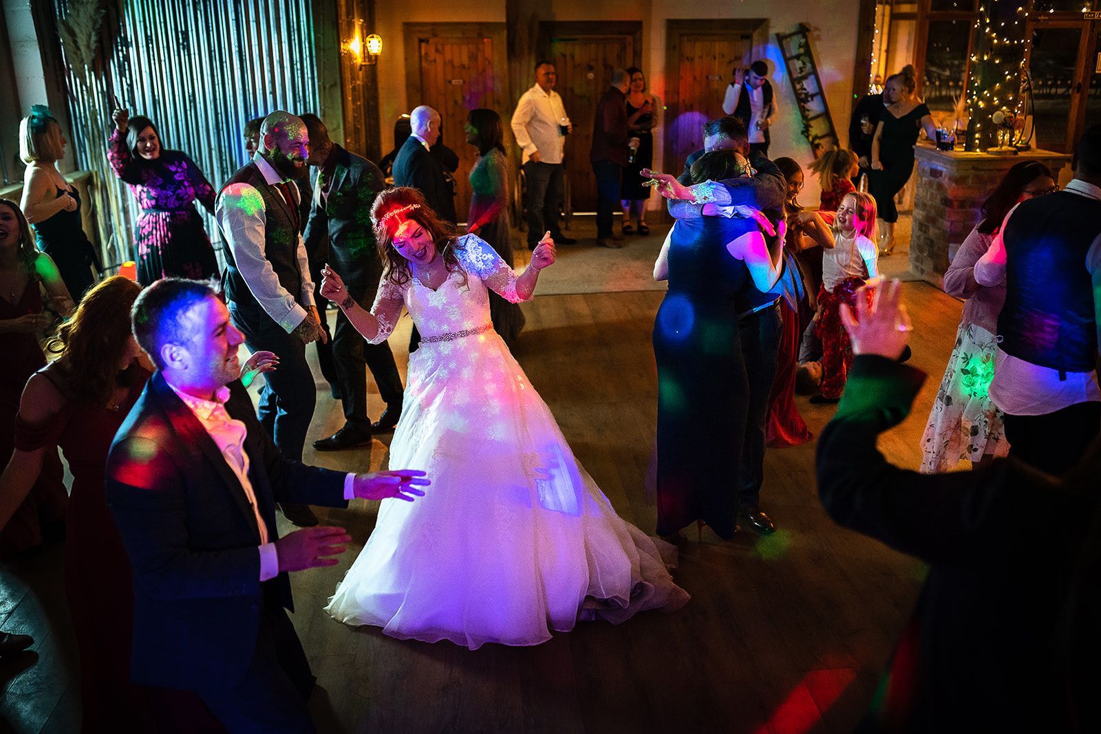 A bride and groom are dancing on a dance floor at their wedding reception.
