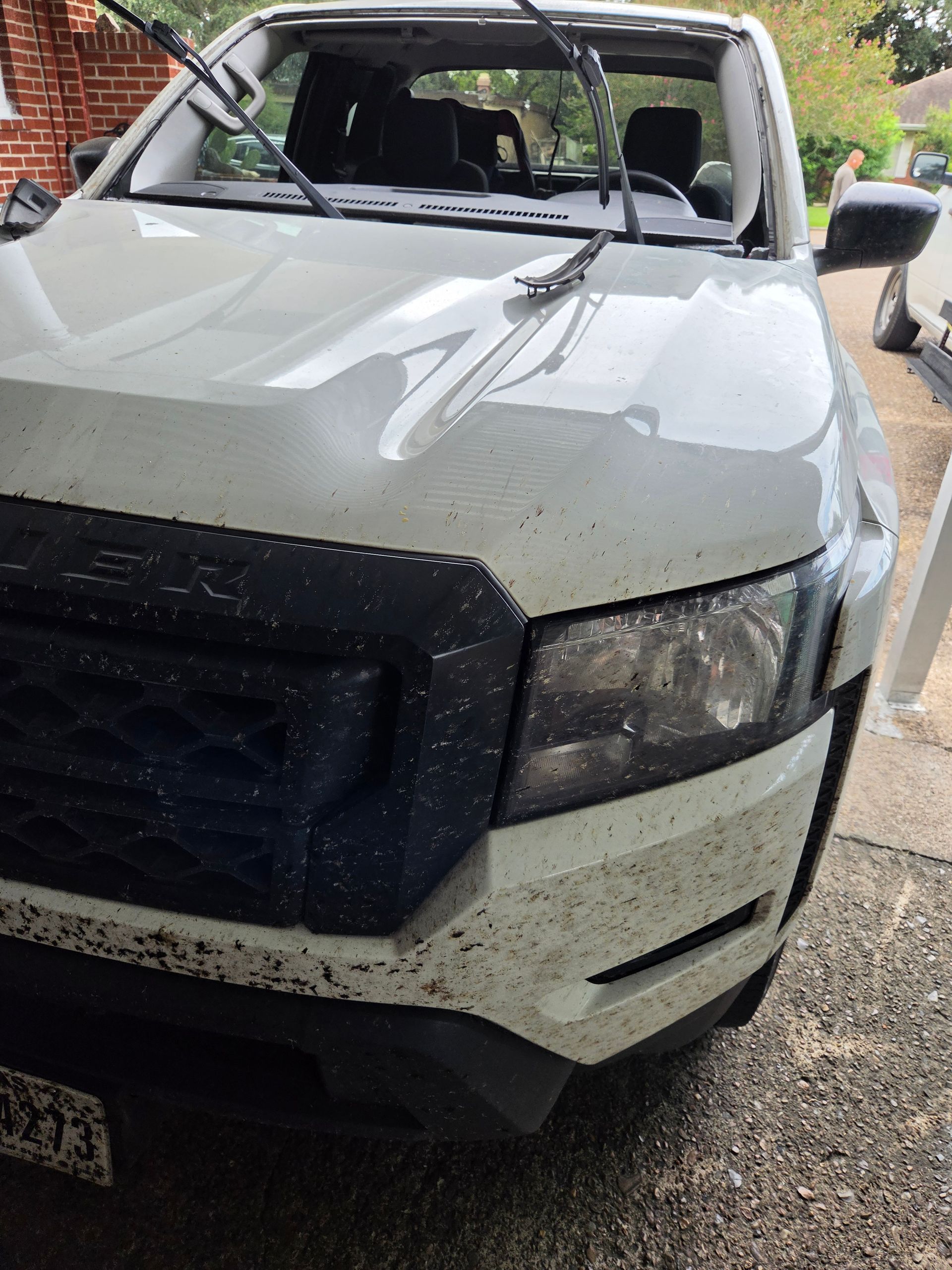 White pickup truck with shattered windshield and damaged front end after an accident