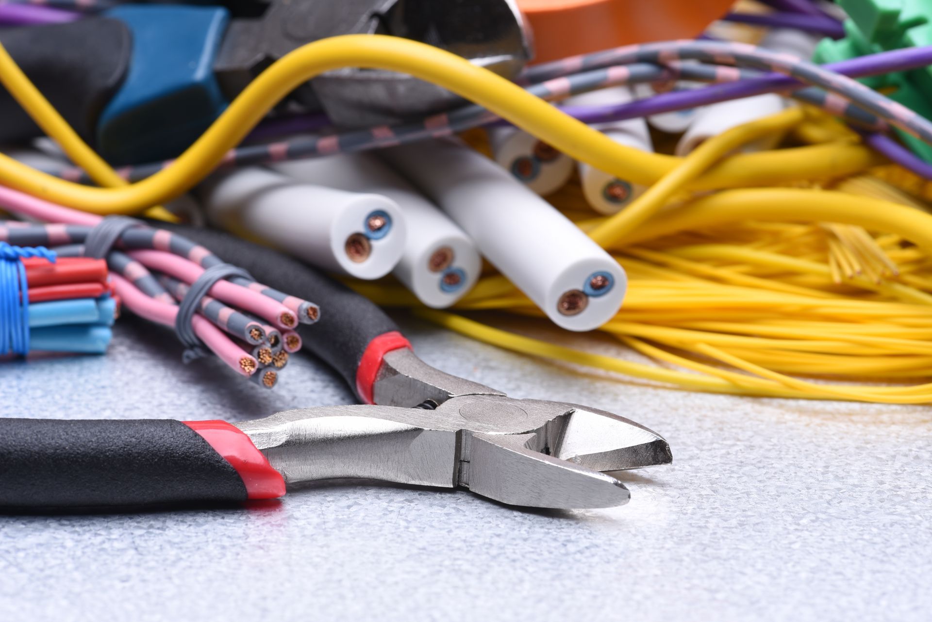 Close-up of electrical wires, tools, and cables in various colors.