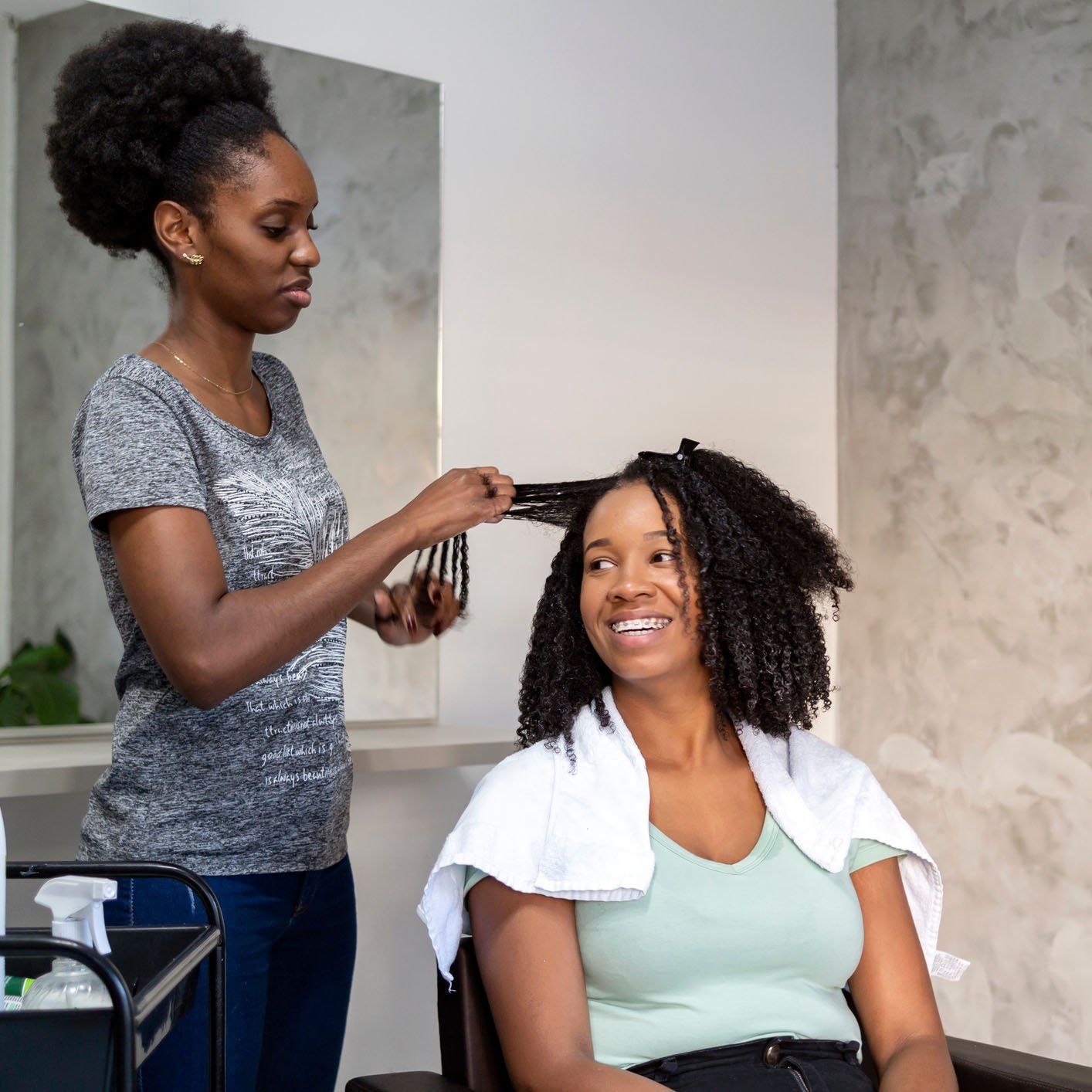 Woman practicing her skills in hair styling — New Carrollton, MD — Hair Academy