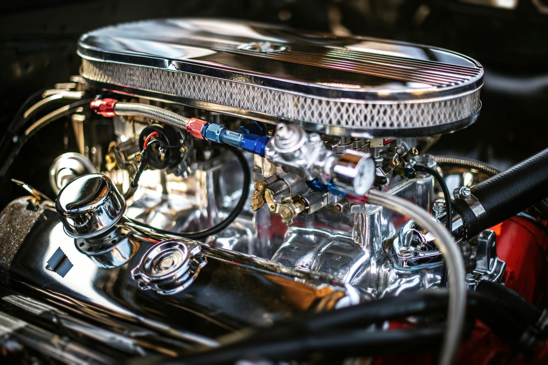 The trunk of a corvette with a red rug and boxes