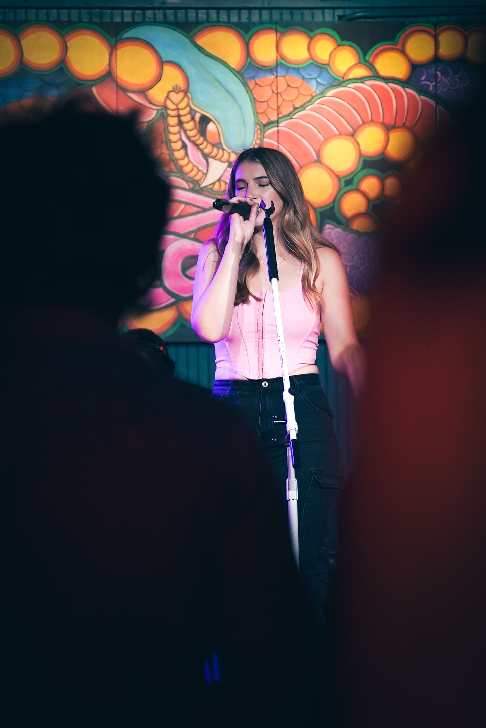A girl sings at a live concert.