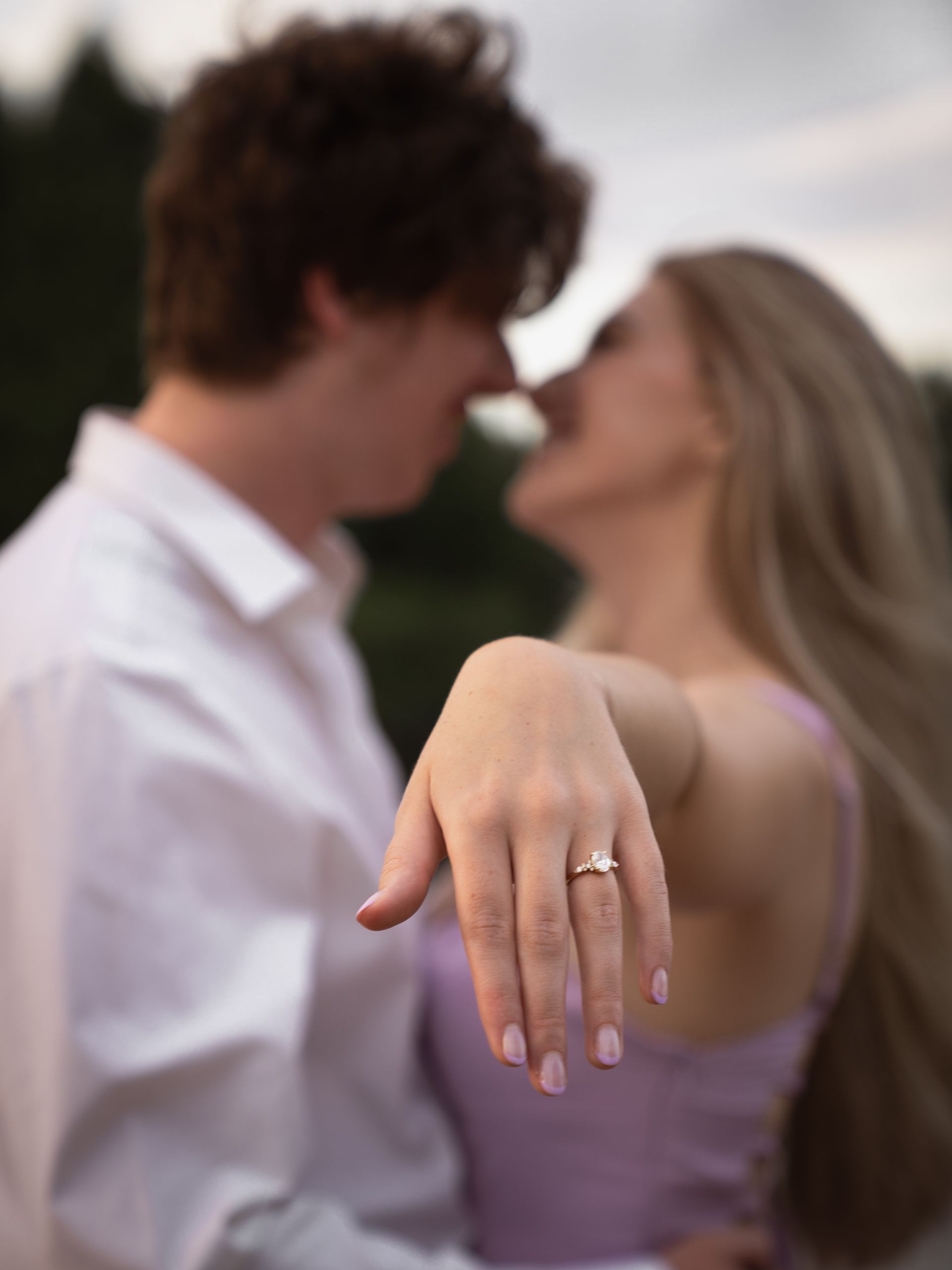 Close up of a woman's hand with an engagement ring on it.