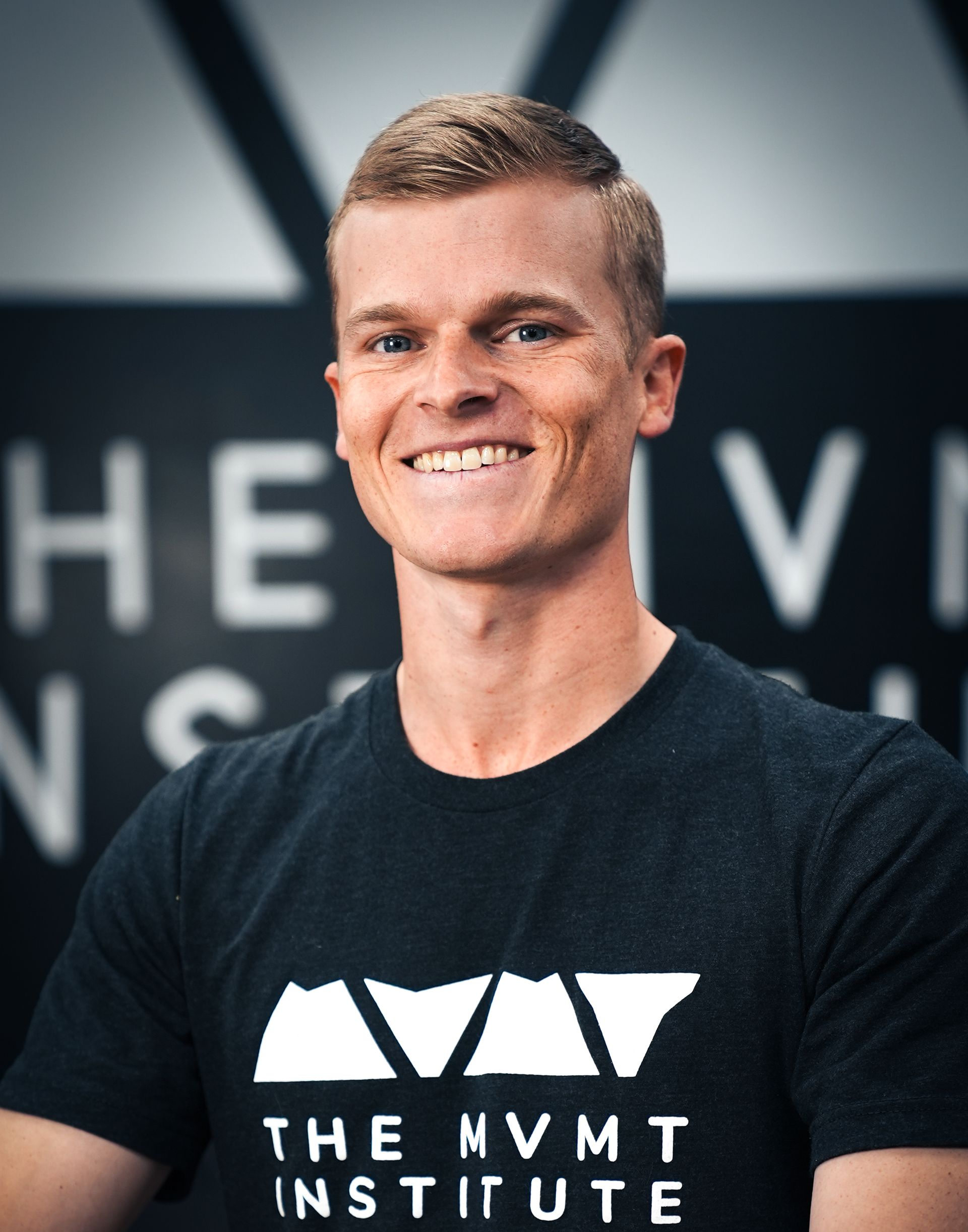 A man poses for a professional headshot.