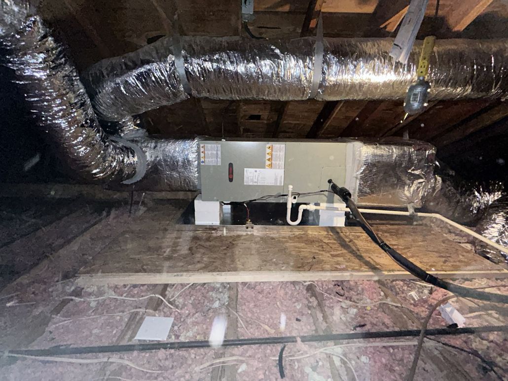 Clipboard checklist in front of large HVAC fan unit for maintenance inspection