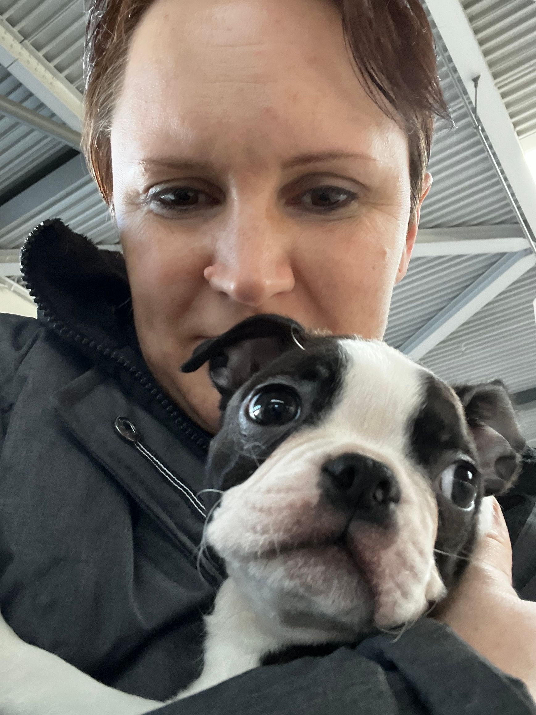 Katrina at airport bringing home Ryker as a puppy
