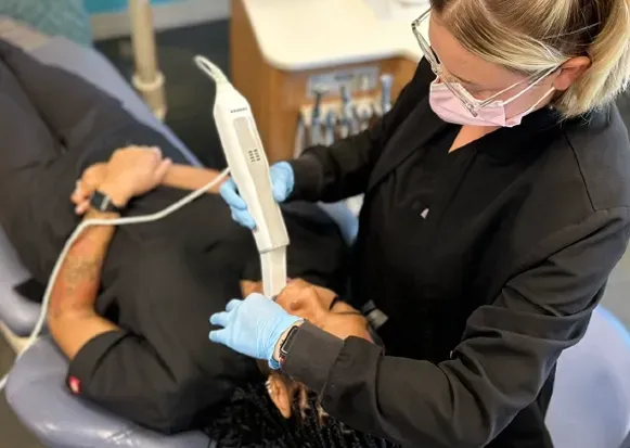 Maple Orthodontics team member assisting a patient during an orthodontic consultation in New Albany, Ohio