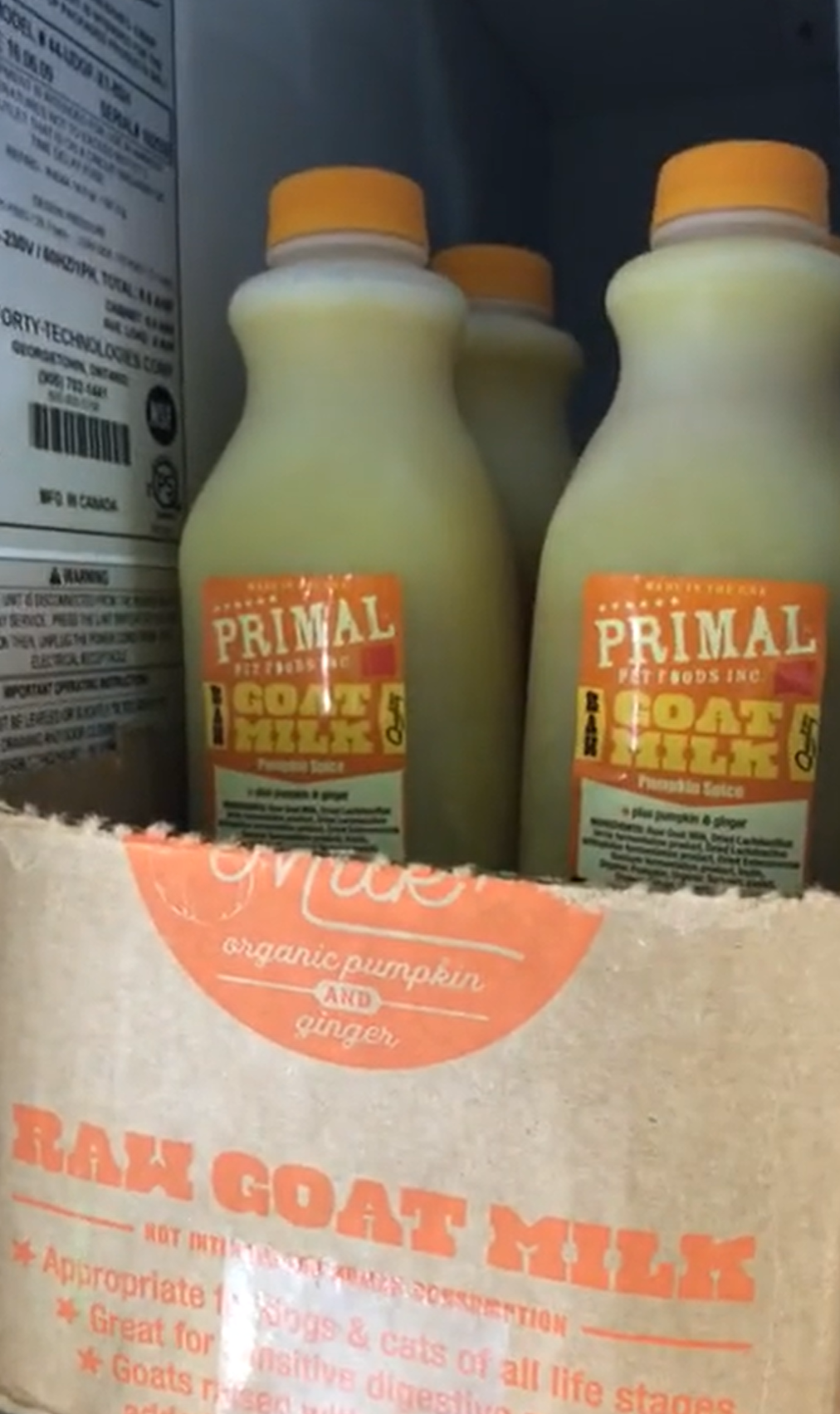 Three bottles of primal goat milk in a bag