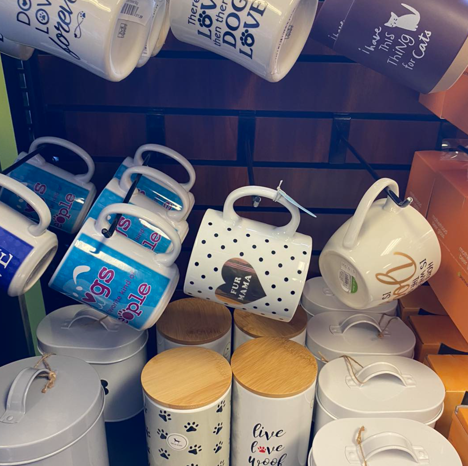 A bunch of coffee mugs with one that says dog love on it