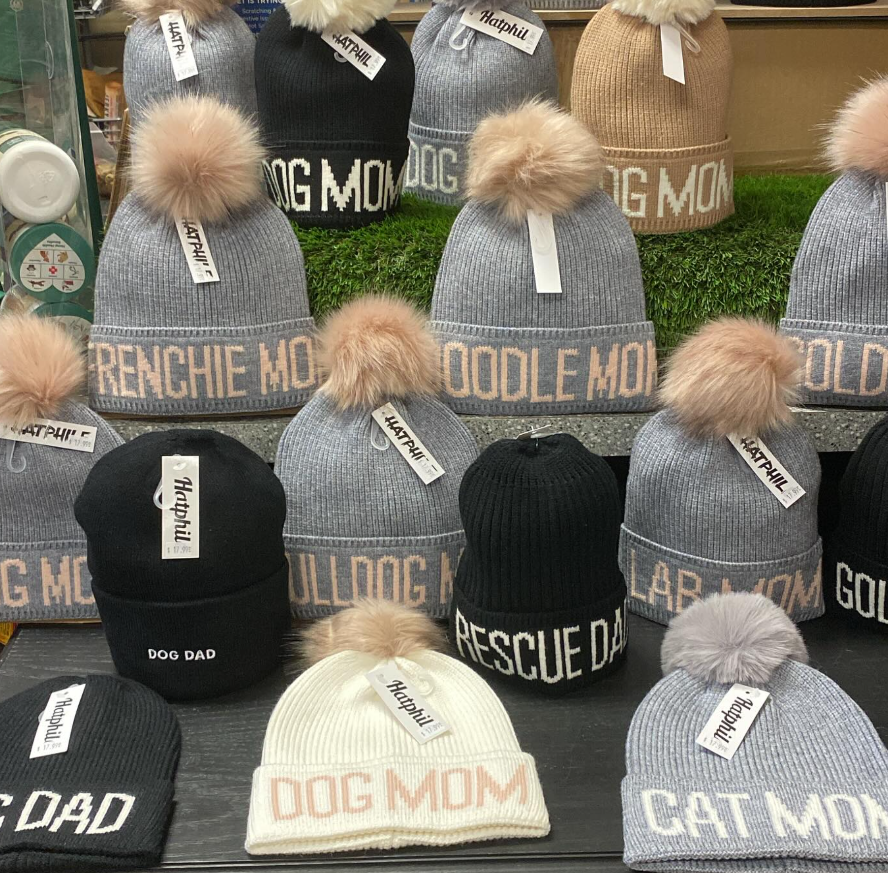 A bunch of hats with the word dog mom on them