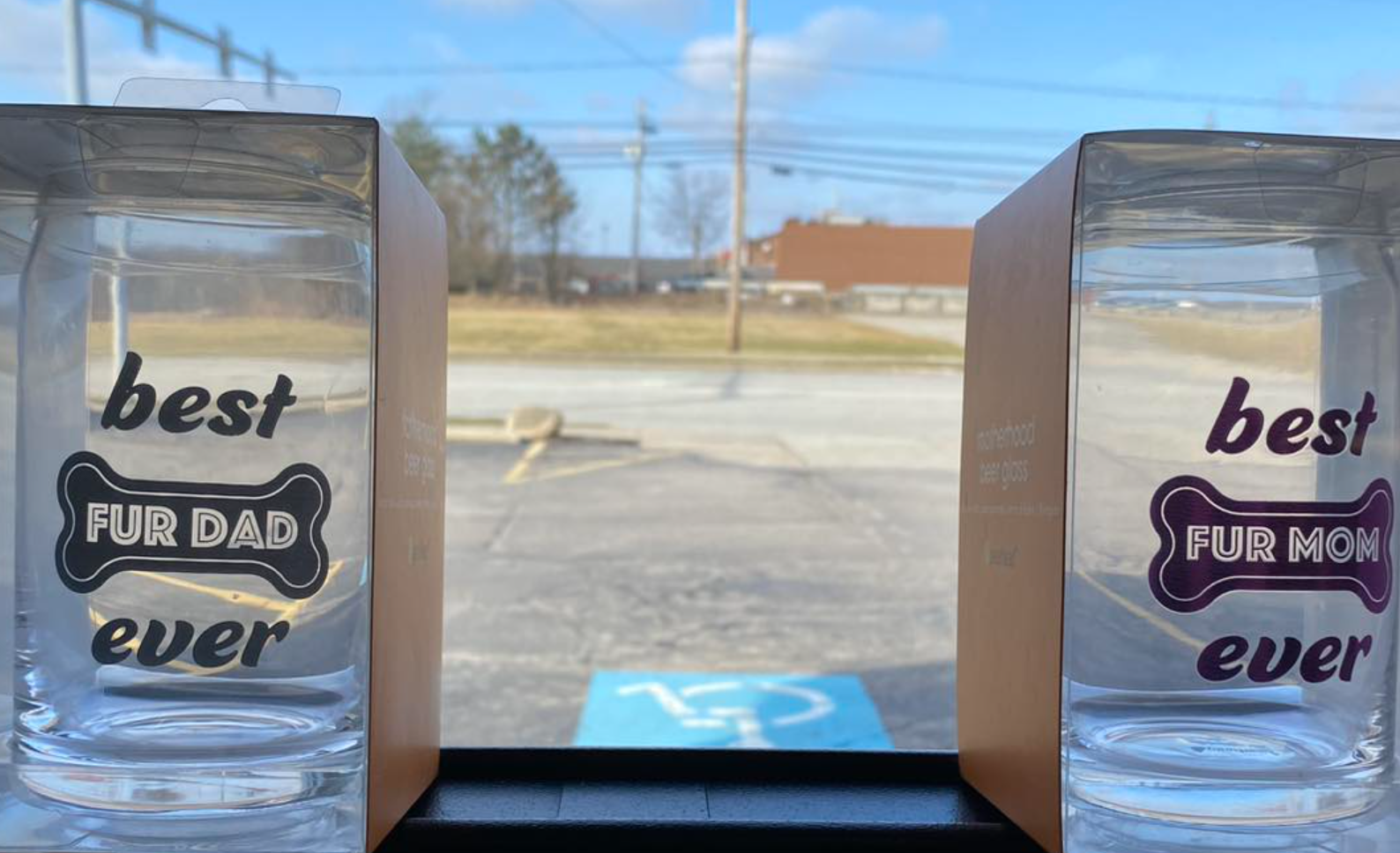 Two glasses that say `` best fur dad ever '' are sitting next to each other on a window sill
