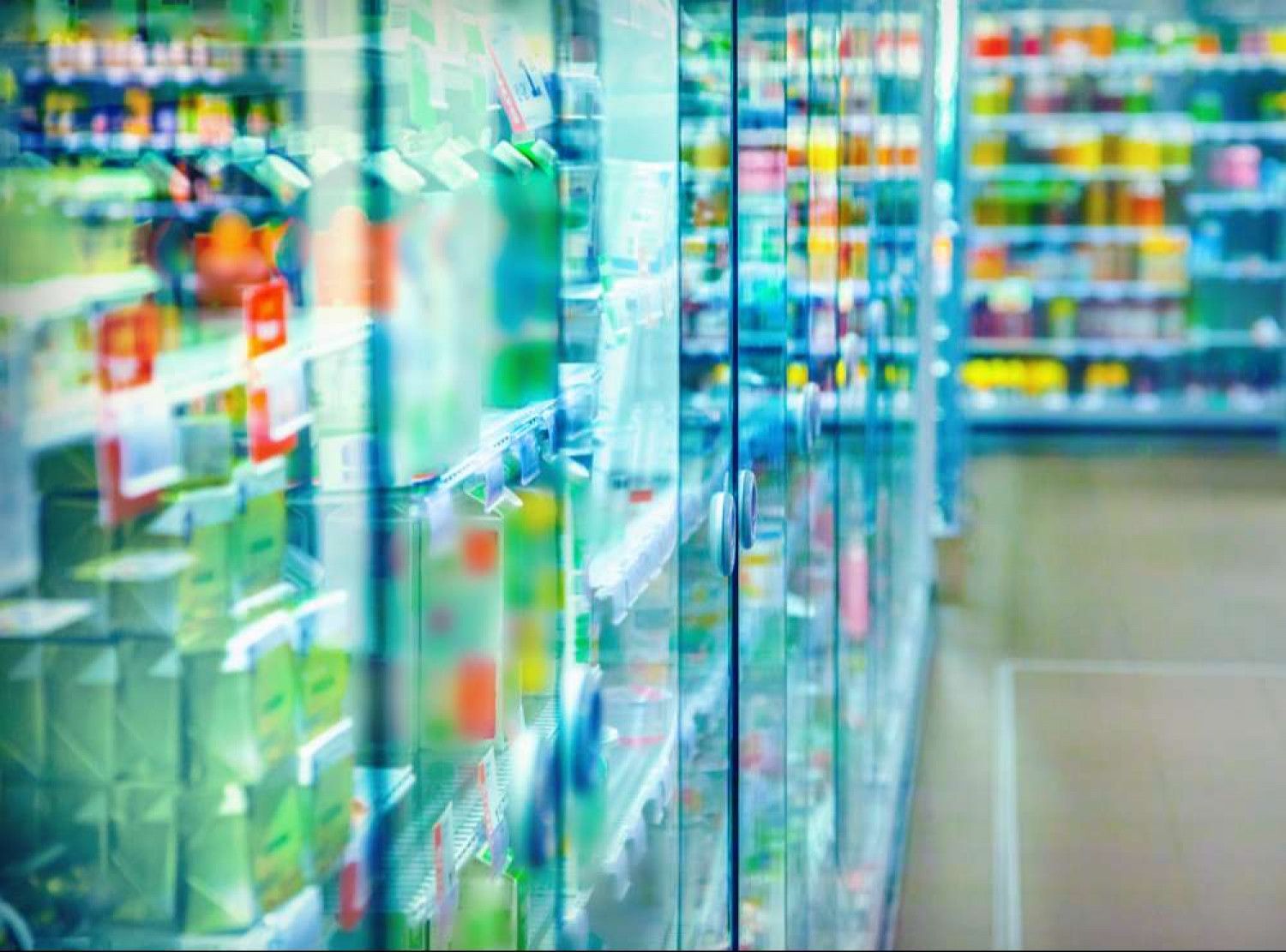 A blurred image of a grocery store with a lot of shelves.