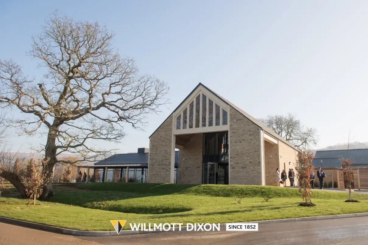 Wilmot Dixon office building with stone facade and pitched roof in a sunny landscaped setting