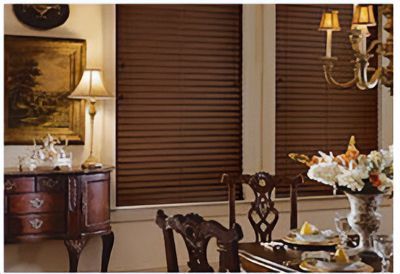 Love is Blinds St. Louis: A dining room with a table, chairs, a chandelier, and honeycomb shades on the windows.