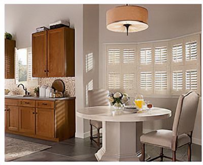 Love is Blinds St. Louis: A kitchen with a table and chairs and shutters on the windows.