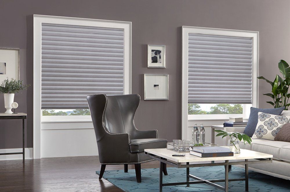 a living room with a couch , chair , coffee table and gray honeycomb shades Love is Blinds Missouri (314) 808-3440 .