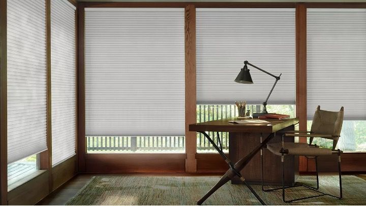 Love is Blinds St. Louis: A living room with a chair and a window with cellular shades.