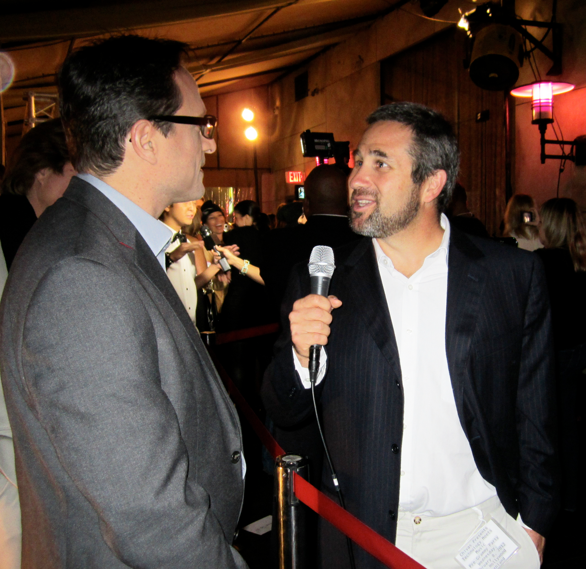 Reporter  interviews Al Conti at event, red carpet.