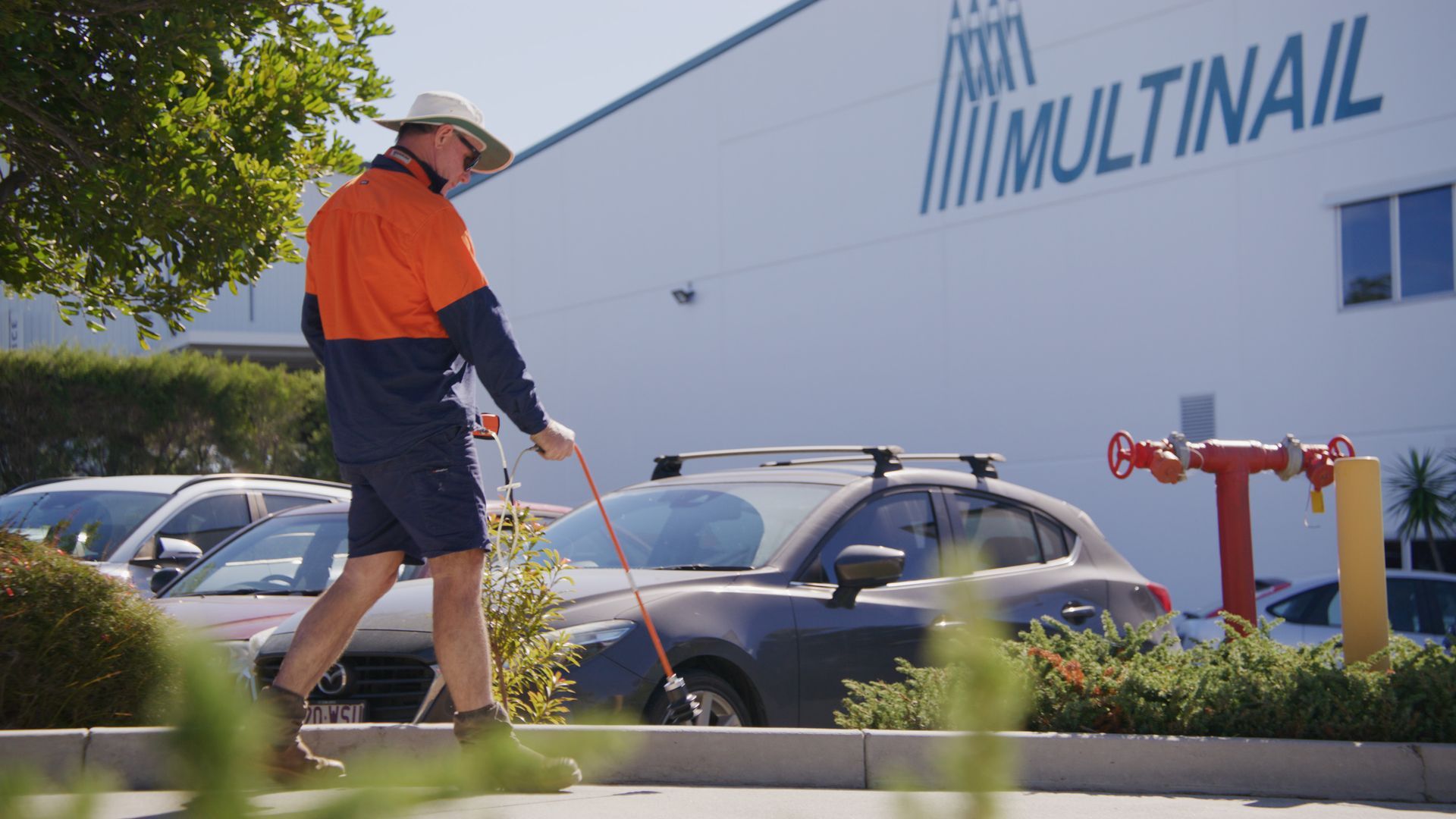 Man in workwear walks near a 