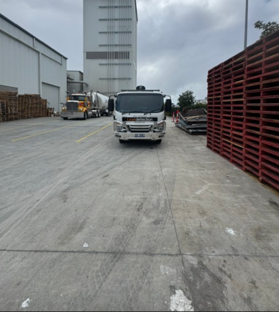 Leak Detection Truck Parked Between Pallet Stacks At Industrial Site &mdash; Commercial Leak Detection in Mudgeeraba, QLD
