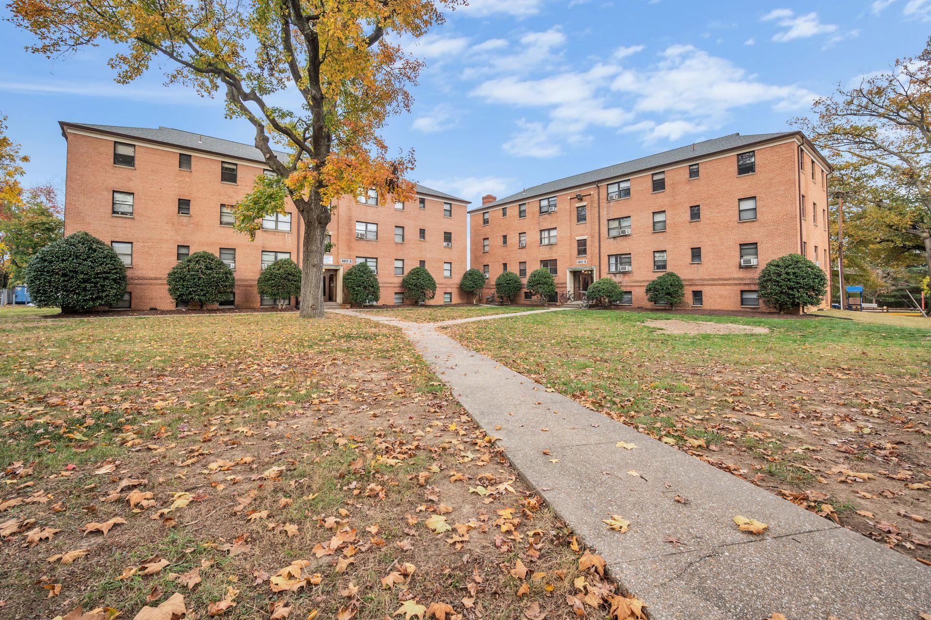 A large brick building with a walkway leading to it.