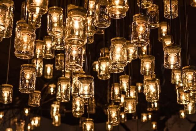 Warm hanging glass lanterns glowing in a dark space