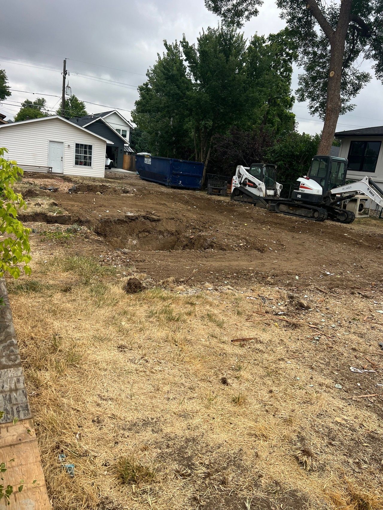 Cleared construction site at 1234 Jefferson Avenue with a detached garage in the background