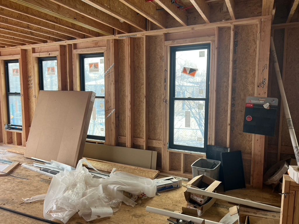 Interior wall framing and windows at 1234 Jefferson Avenue during construction