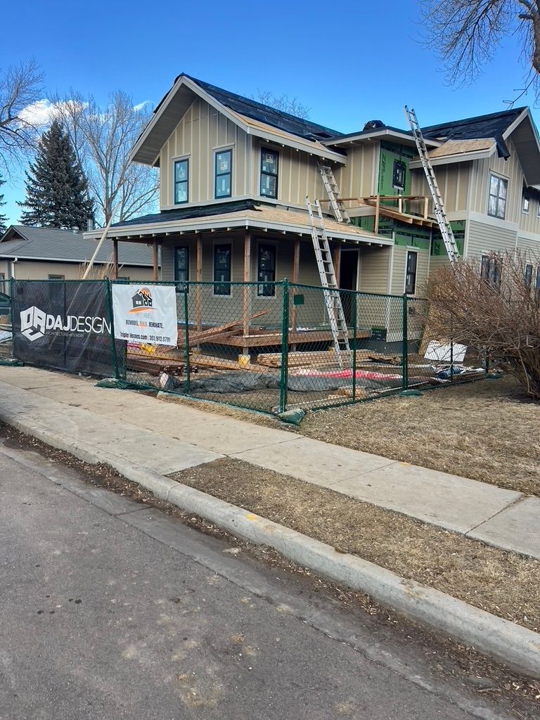 Front exterior of 1234 Jefferson Avenue with siding and construction fencing