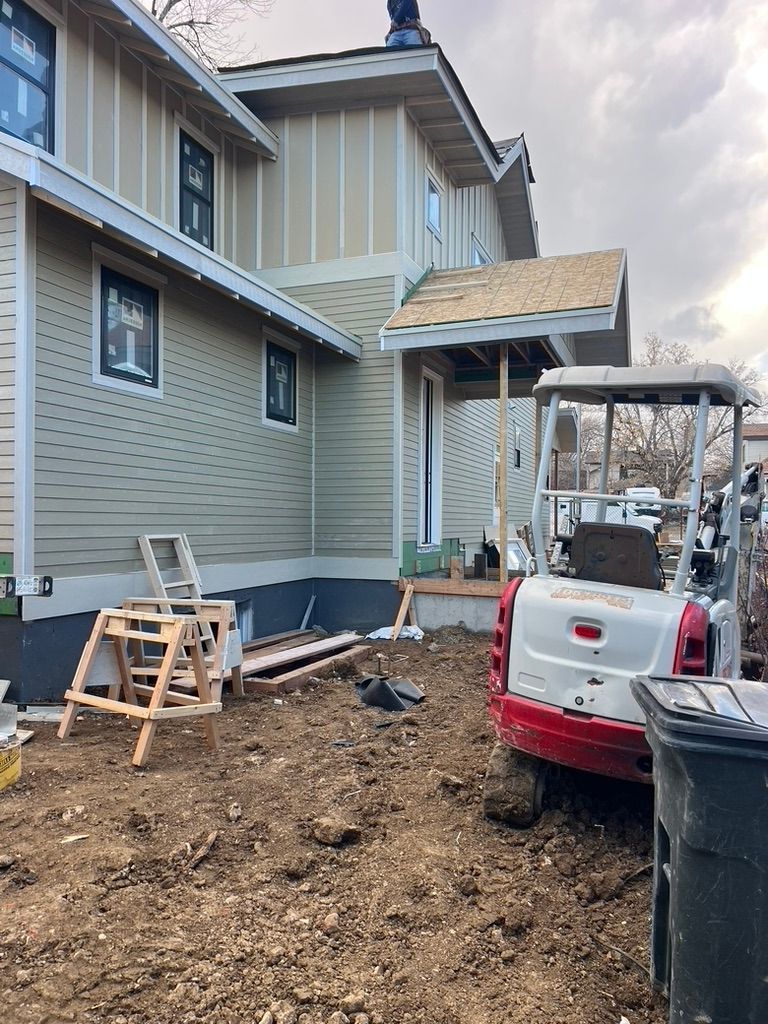 Exterior siding and excavation equipment at 1234 Jefferson Avenue during construction