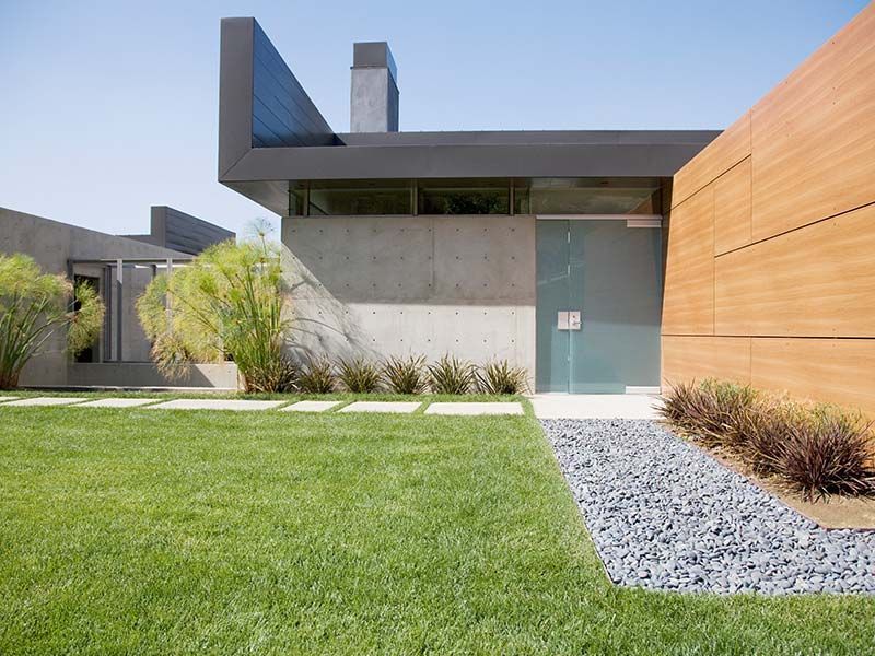 A modern house with a large lawn in front of it