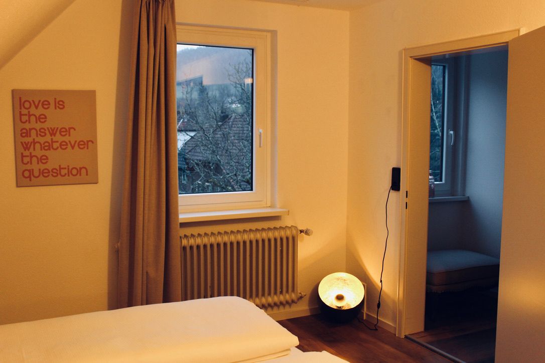 Triple Room windows with a sign on the wall that says love is the answer whatever the question