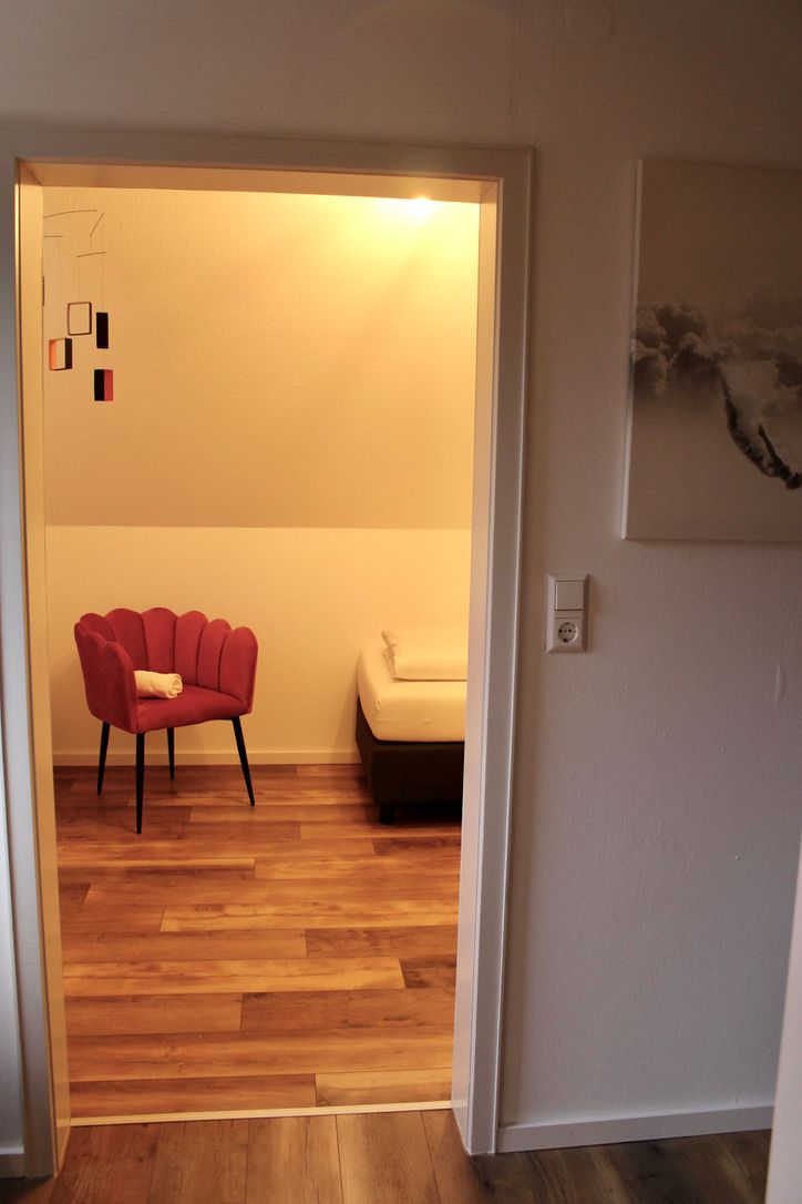 Triple Room A room with a chair and a bed in it