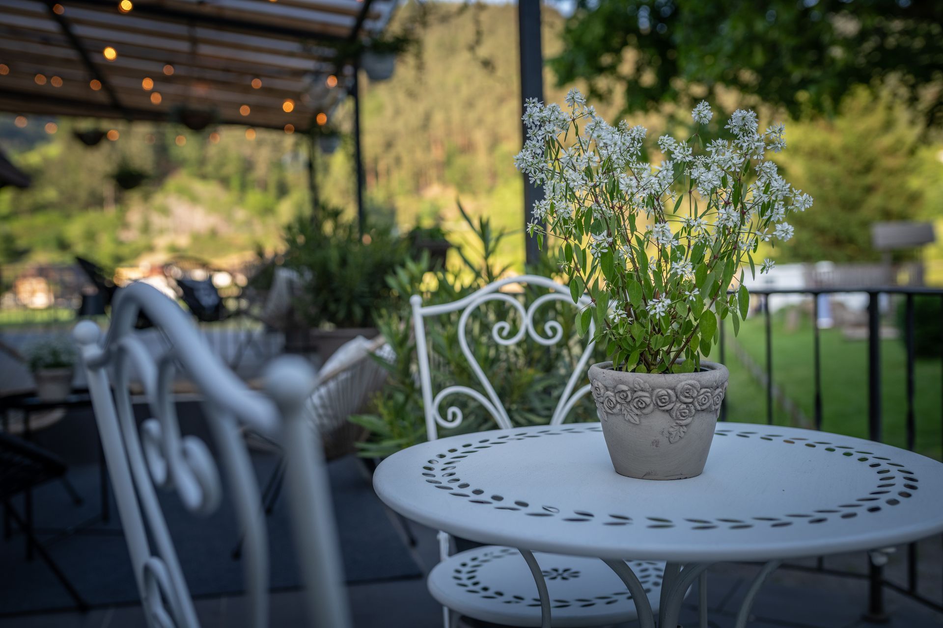 A white table with a potted plant on it.