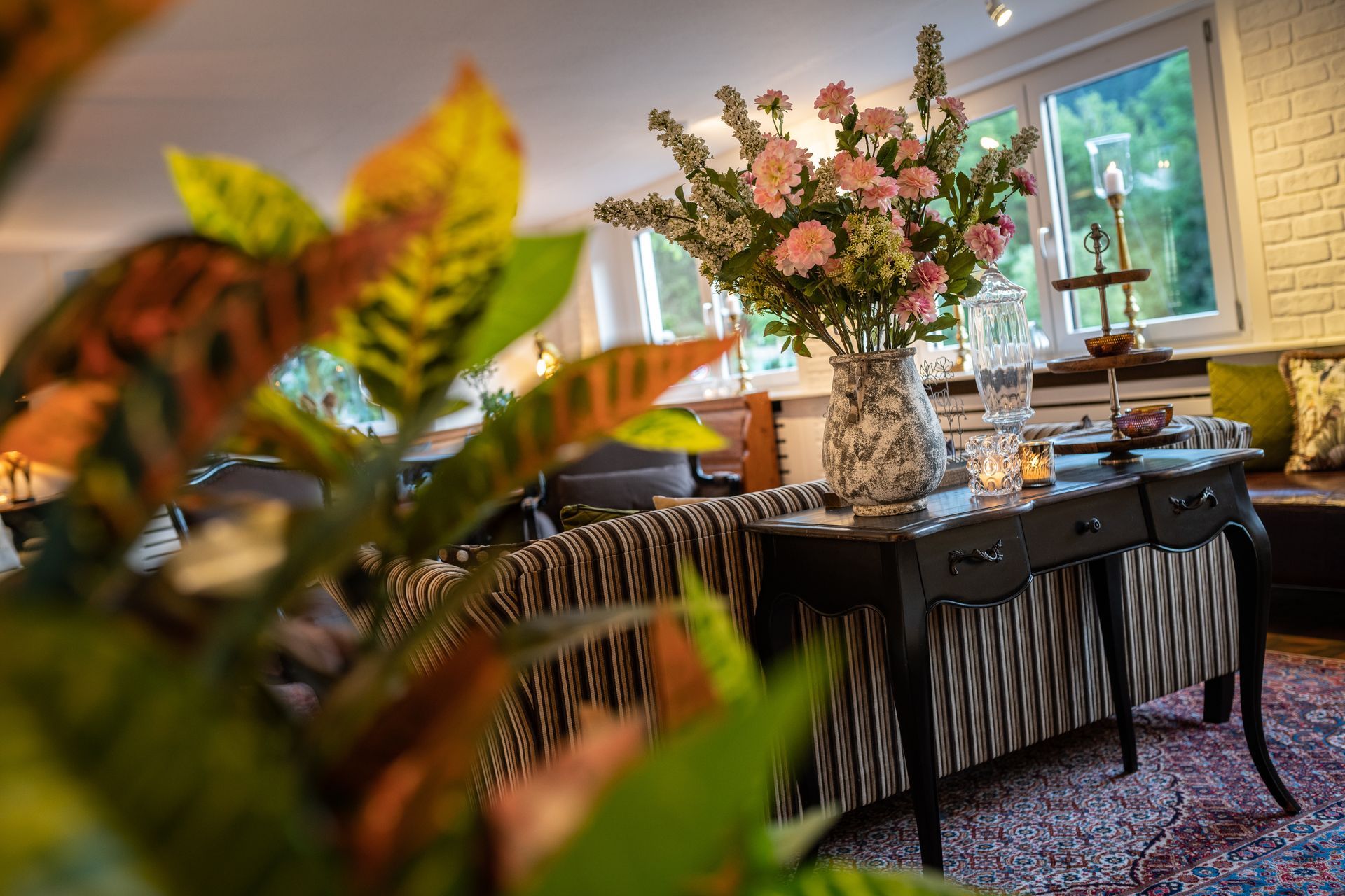 A living room with a vase of flowers on a table
