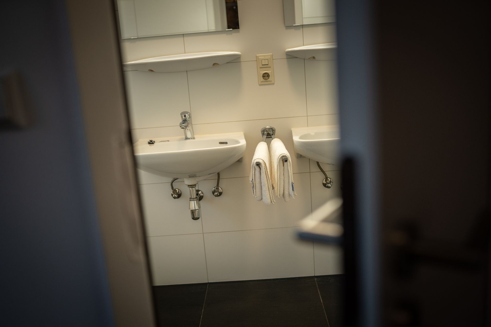 A bathroom with two sinks and a mirror