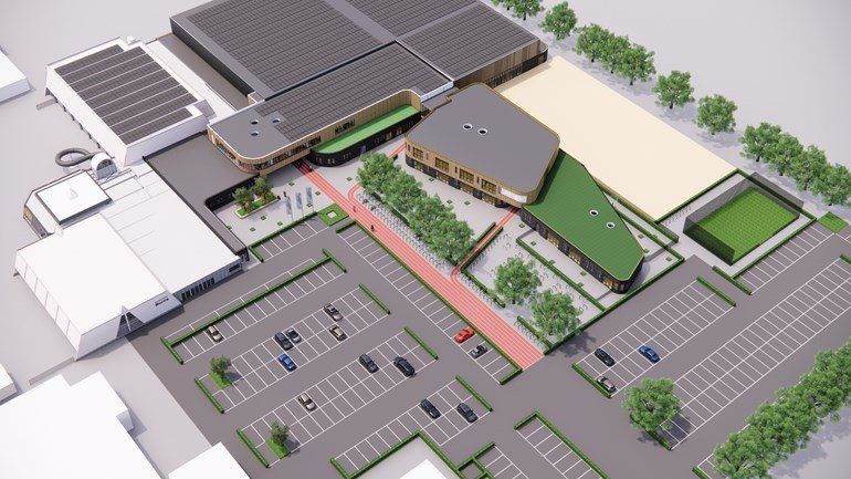 Luchtfoto-rendering van een commercieel gebouwencomplex met parkeergelegenheid, groene zones en zonnepanelen.