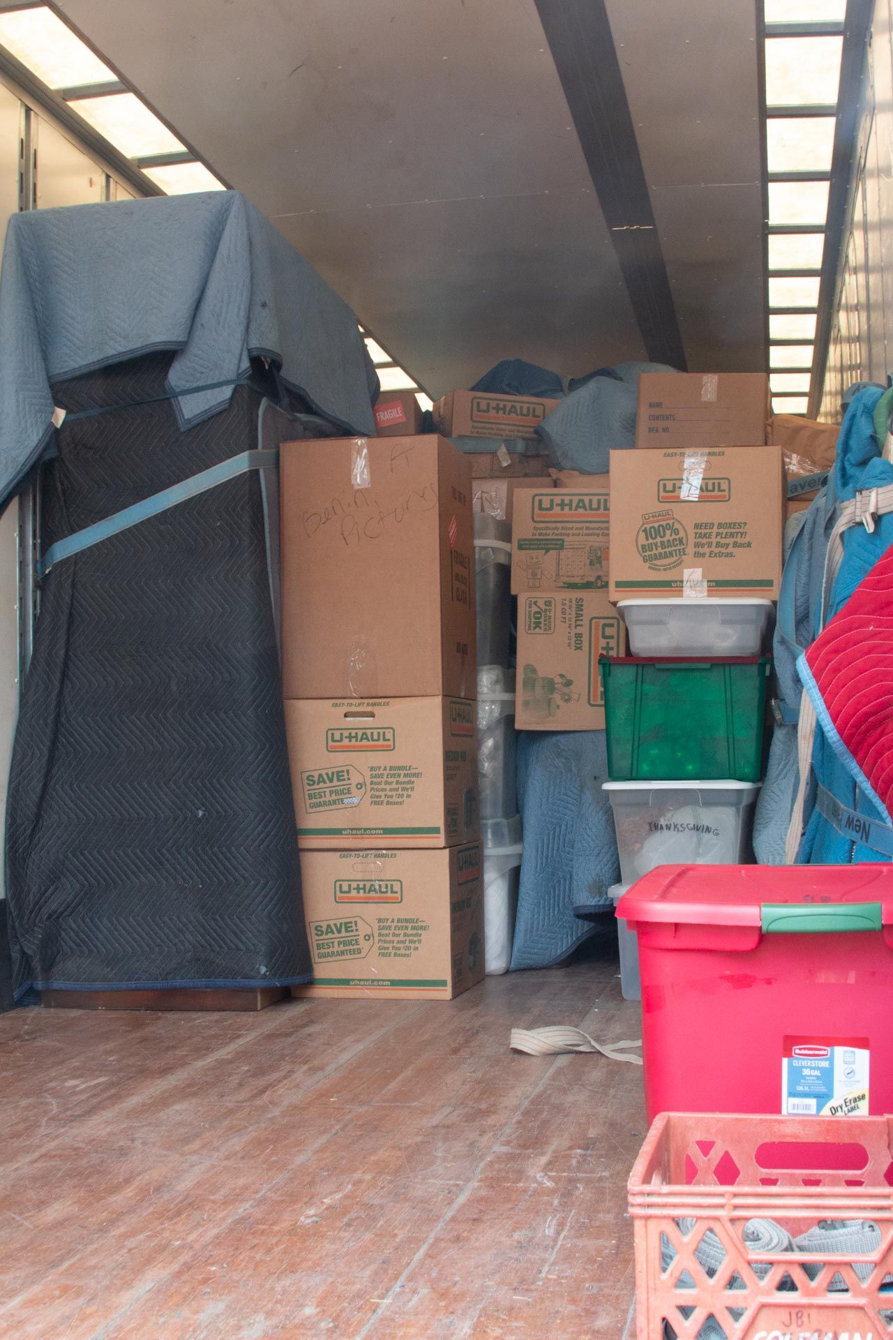 The inside of a moving truck filled with boxes and crates
