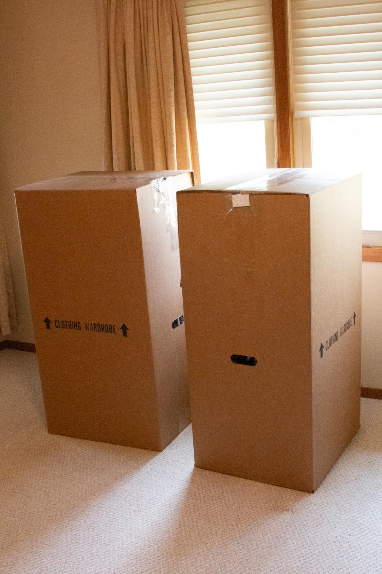 Two cardboard boxes are sitting next to each other in a room