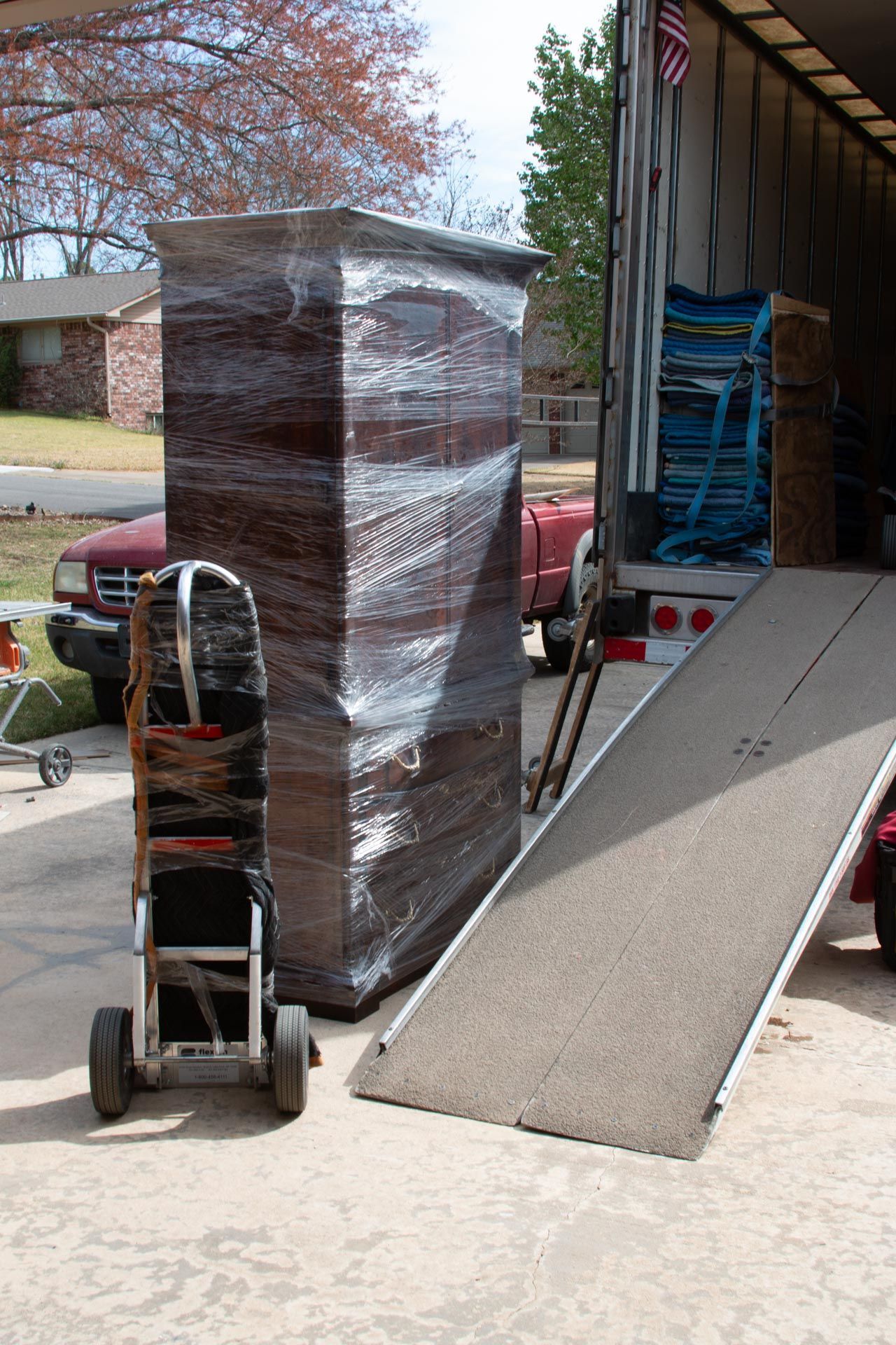 A large piece of furniture is being loaded into a moving truck