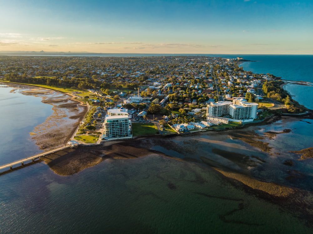 An Aerial View Of A City Next To A Body Of Water — Tom Thumbs Tree Works In Redcliffe, QLD