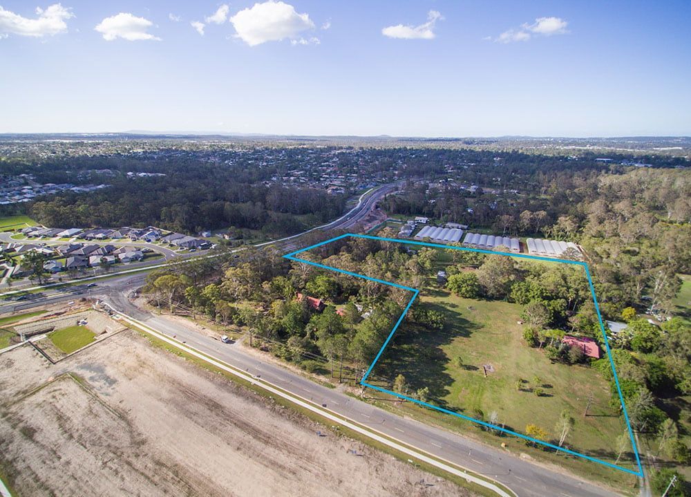 An Aerial View Of A Residential Area With A Road And Trees — Harrison Development Group In Surfers Paradise, QLD