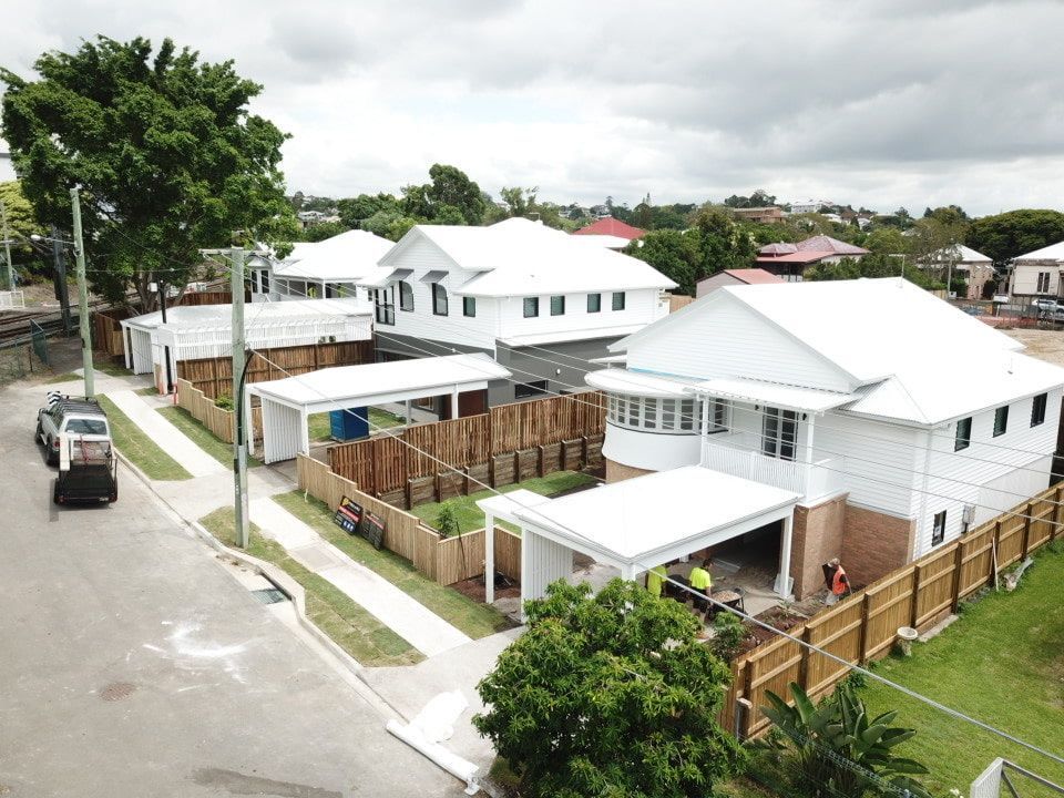 An Aerial View Of A Row Of White Houses On A Residential Street โ Harrison Development Group In Surfers Paradise, QLD